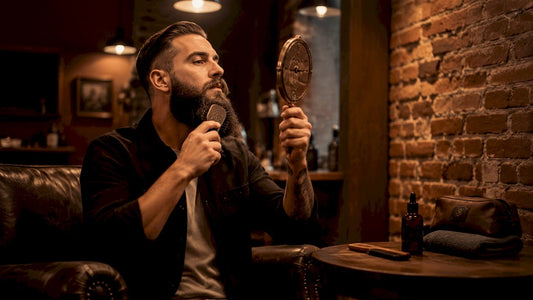 Man brushing beard in bathroom mirror