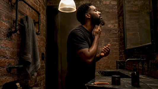 Man applying beard oil in bathroom