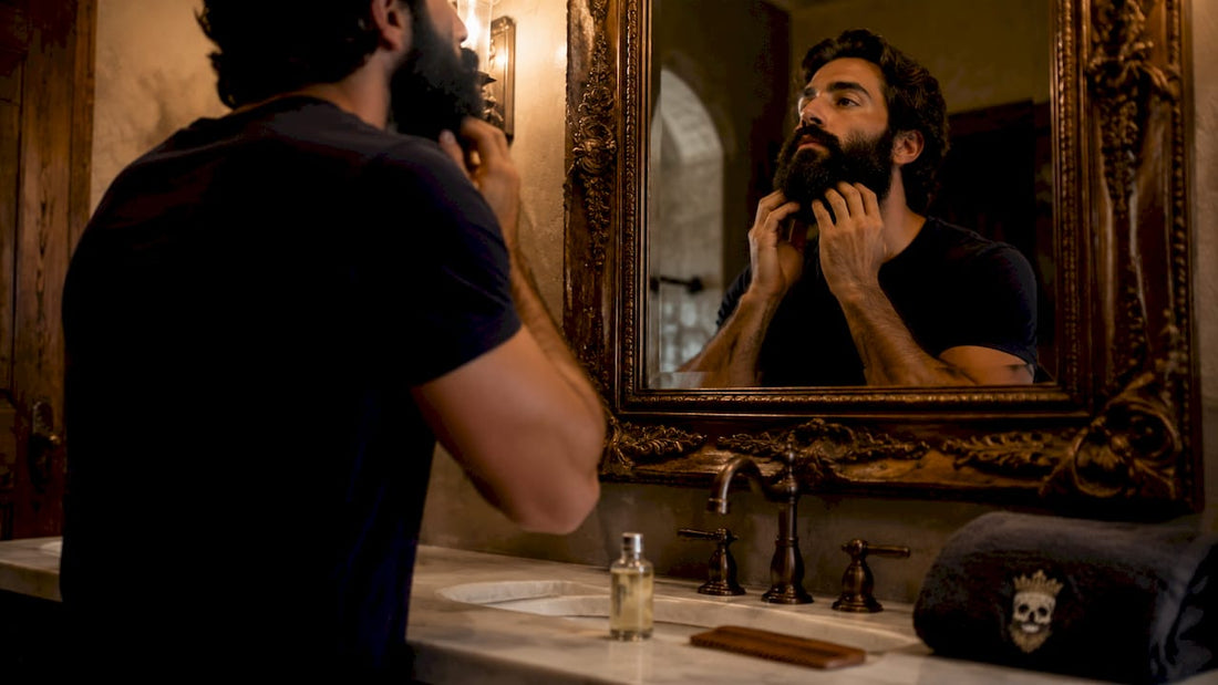 Man applying argan oil to his beard in bathroom mirror