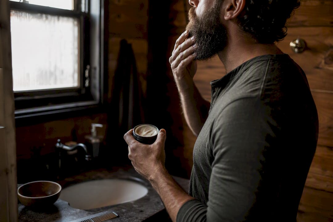 Man applying beard butter to coarse beard