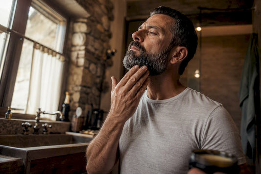 Man applying beard balm side close-up