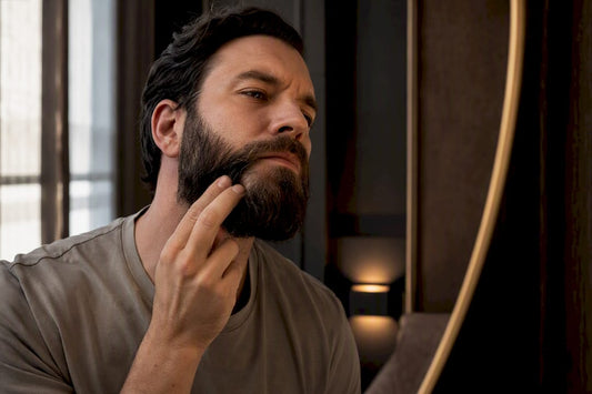 Man inspecting sensitive skin beneath beard