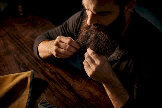 Man sectioning a coarse beard by hand